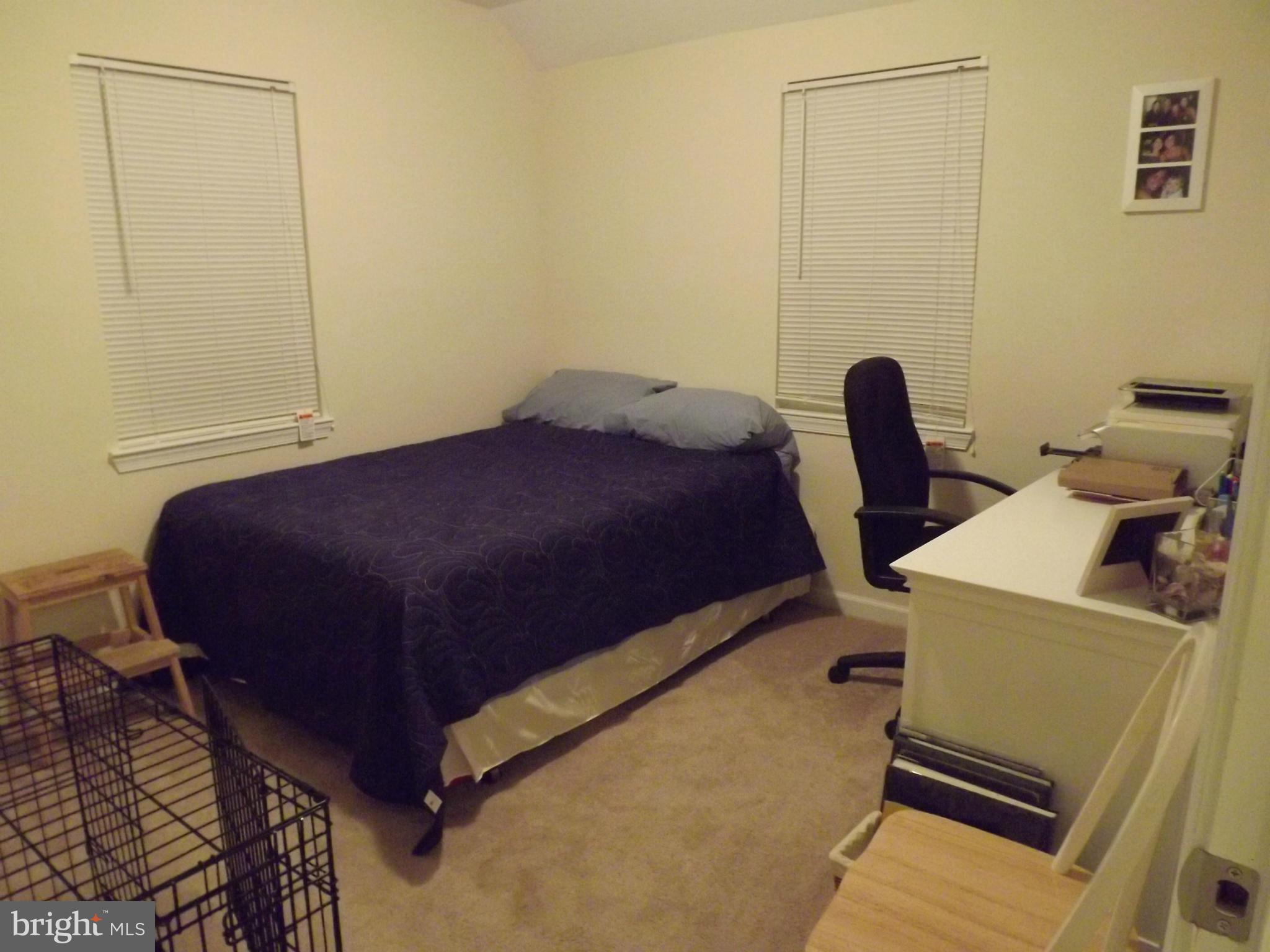 3167 Baybriar Road Baltimore, MD 21222 - Photo 4 of 30 a bedroom with a bed and wooden floor