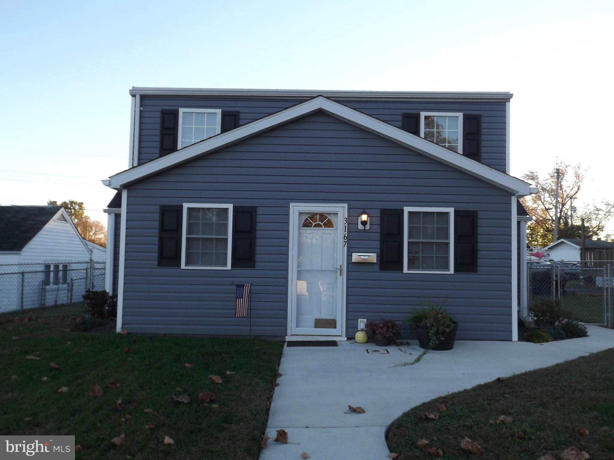 3167 Baybriar Road Baltimore, MD 21222 - Photo 6 of 30 a front view of a house with a yard