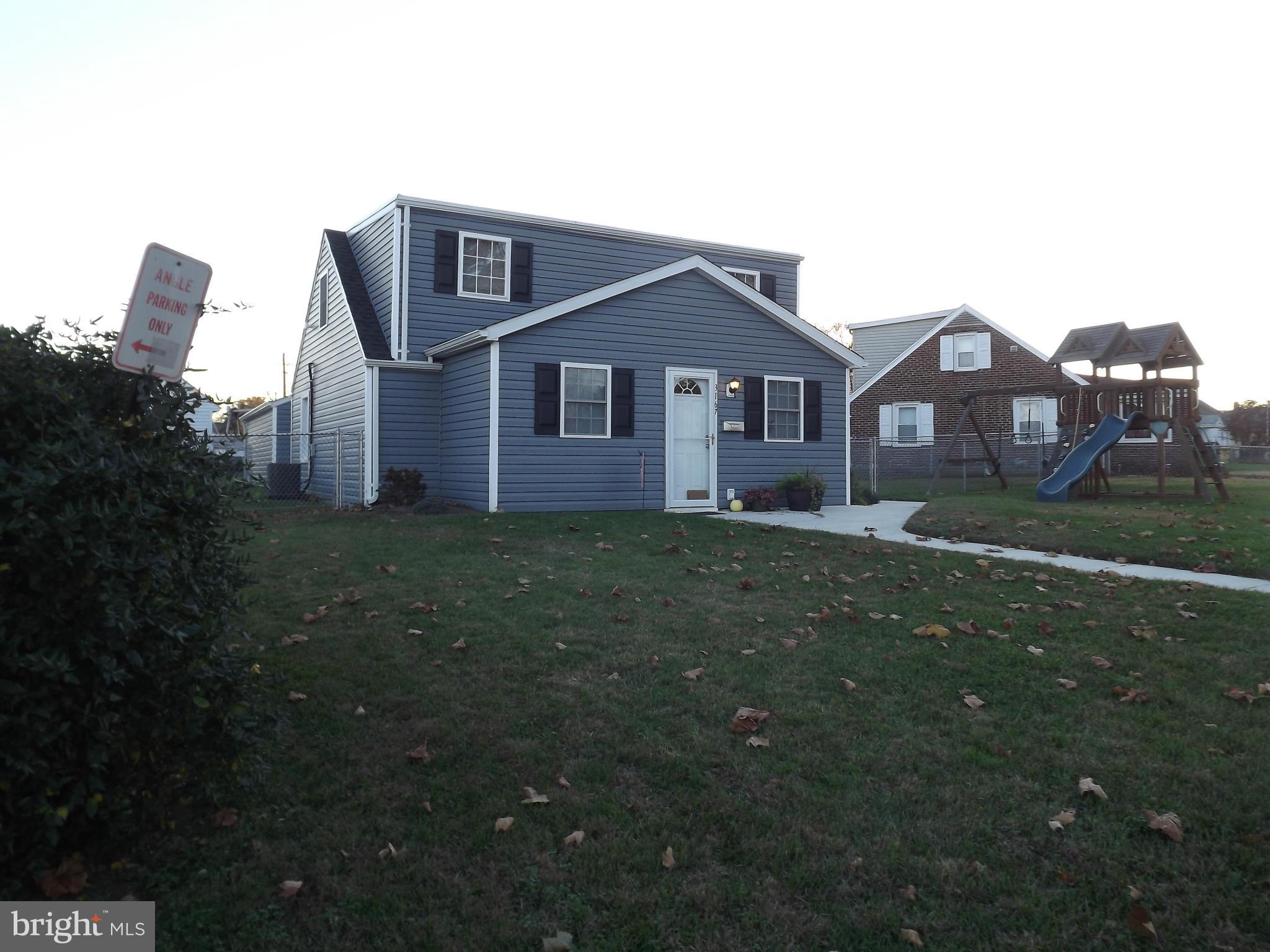 3167 Baybriar Road Baltimore, MD 21222 - Photo 10 of 30 a front view of a house with a yard