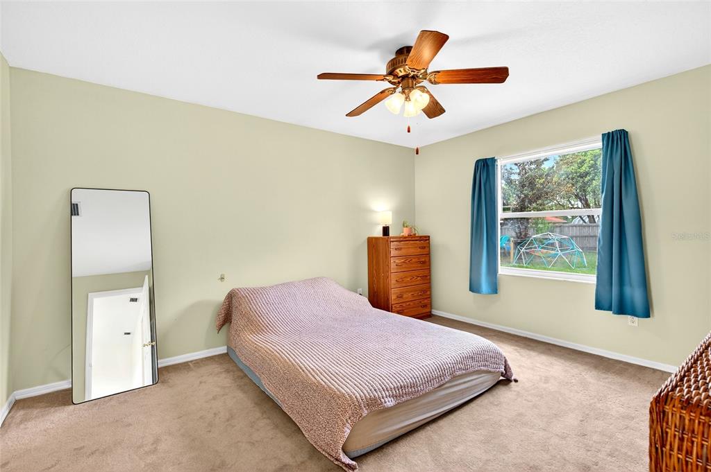 10 Almond Trace Ocala, FL 34472 - Photo 15 of 29 a bedroom with a bed and a chandelier