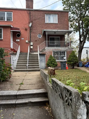a view of a house with wooden fence