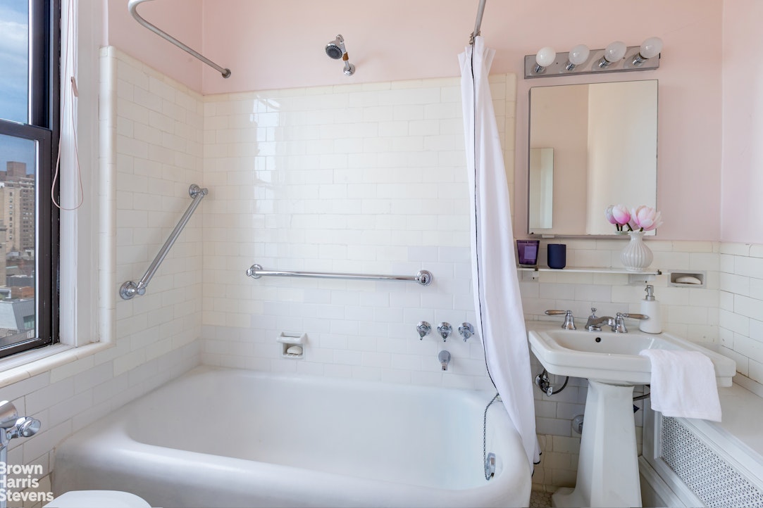 37 Riverside Drive, Unit 10B Manhattan, NY 10023 - Photo 17 of 25 a white bath tub sitting next to a white sink and vanity
