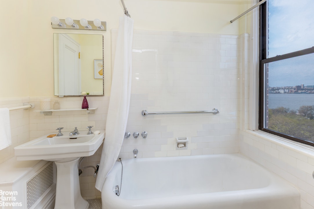 37 Riverside Drive, Unit 10B Manhattan, NY 10023 - Photo 18 of 25 a bathroom with a bathtub sink and mirror