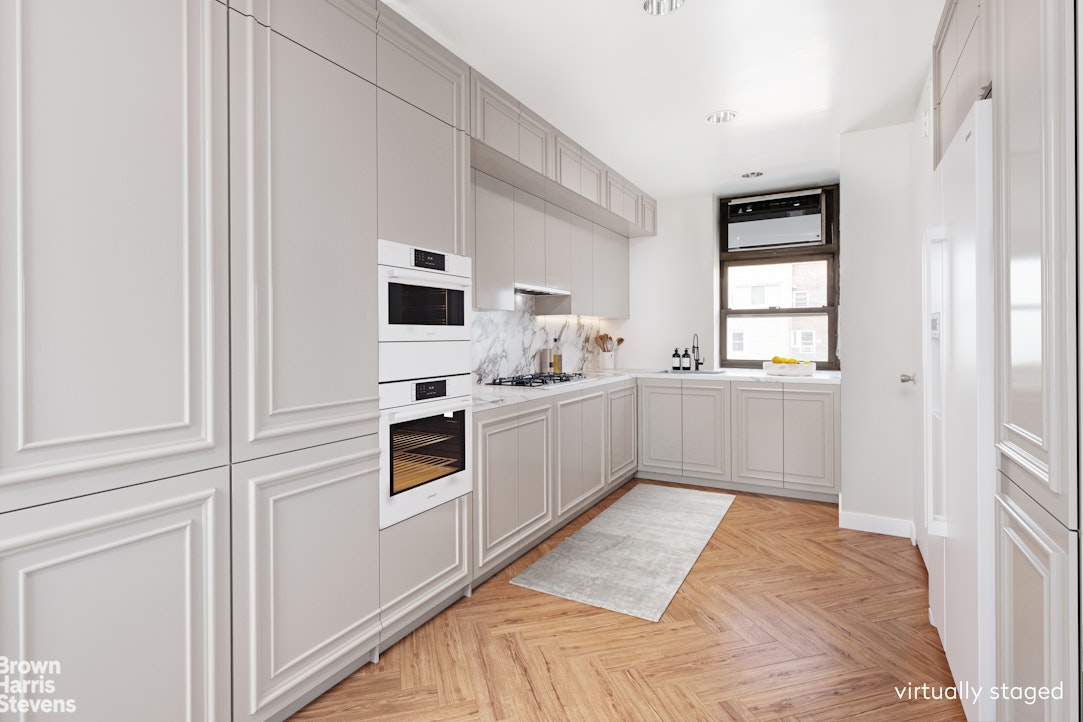 37 Riverside Drive, Unit 10B Manhattan, NY 10023 - Photo 4 of 25 a kitchen with stainless steel appliances a refrigerator and a sink
