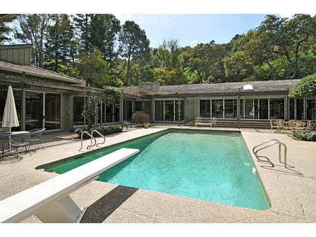 a view of a house with swimming pool and porch