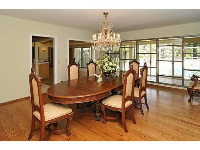 225 Robin Road Hillsborough, CA 94010 - Photo 6 of 18 a dining room with furniture a chandelier and wooden floor