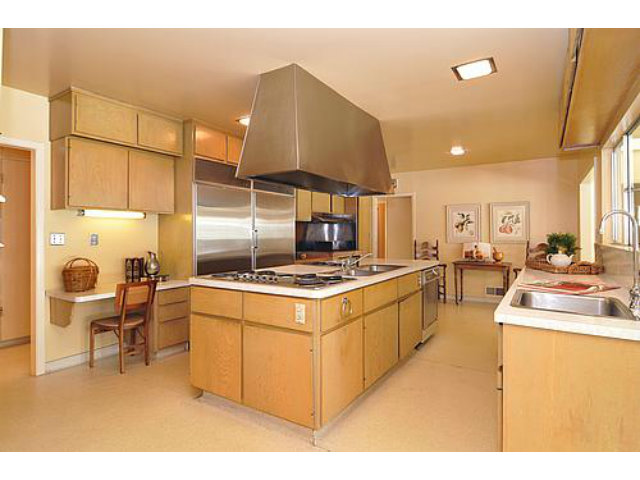 225 Robin Road Hillsborough, CA 94010 - Photo 7 of 18 a kitchen with kitchen island a stove a sink and a refrigerator