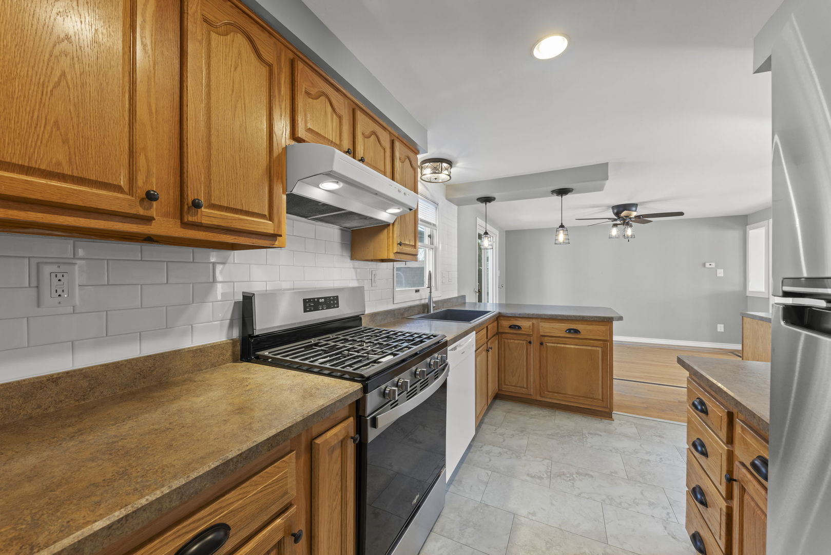 548 Jo Ann Court Lockport, IL 60441 - Photo 9 of 20 a kitchen with stainless steel appliances granite countertop a stove and a sink