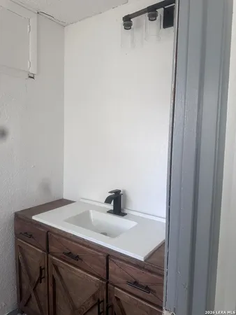 a bathroom with a sink and mirror