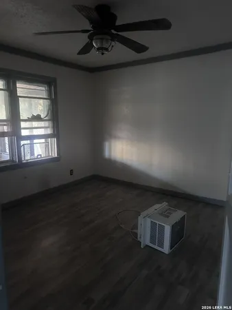 a kitchen with a fridge and wooden floor