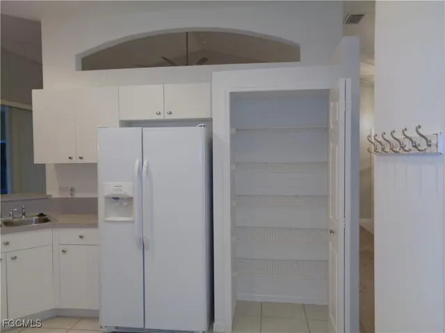a kitchen with cabinets and white appliances