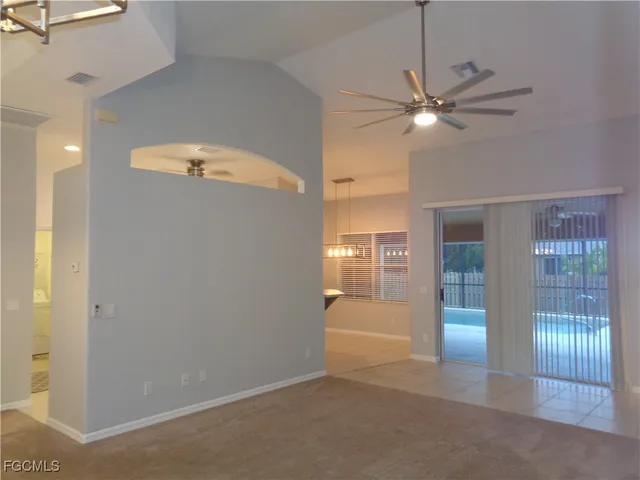 a view of a livingroom with a ceiling fan and window