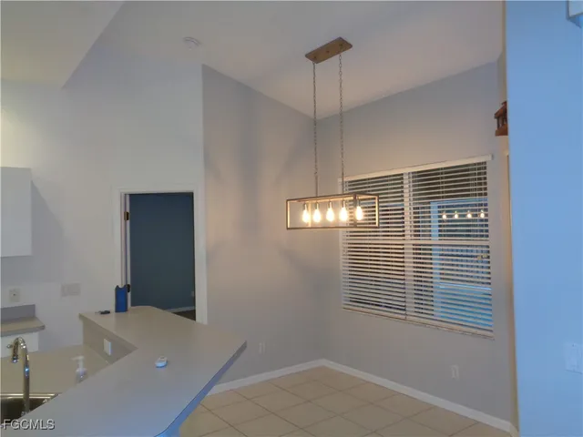 a view of a room with a window and chandelier