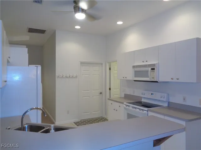 a kitchen with stainless steel appliances a sink stove and cabinets