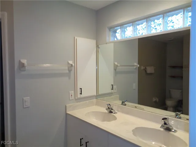 a bathroom with a sink double vanity and a mirror