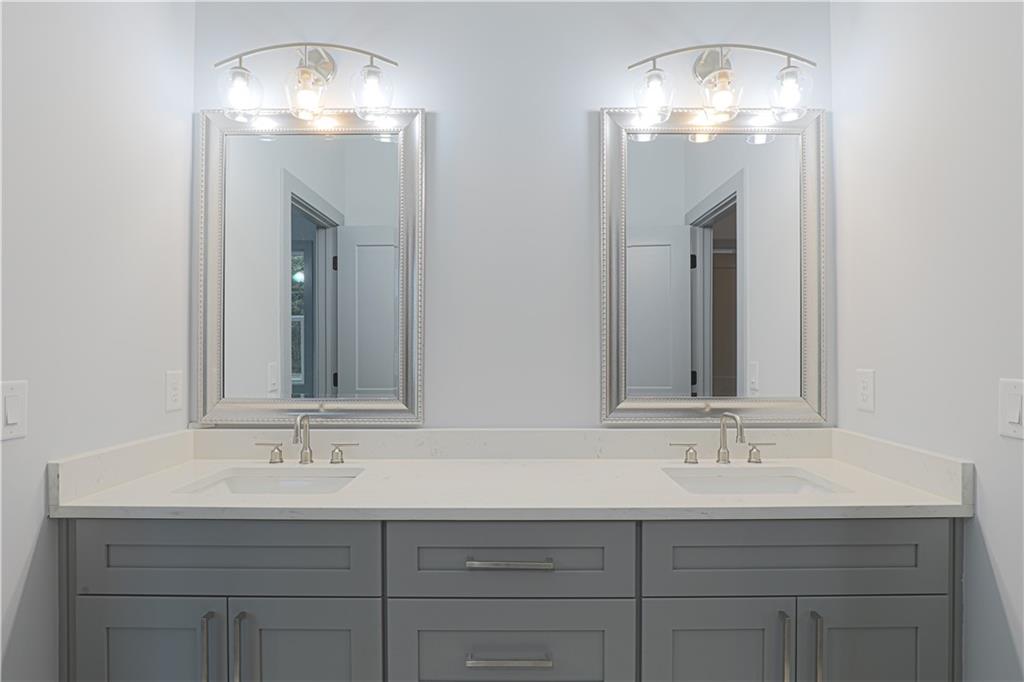 1341 Wheeler Creek Road Maysville, GA 30558 - Photo 38 of 51 a bathroom with double sink and a mirror