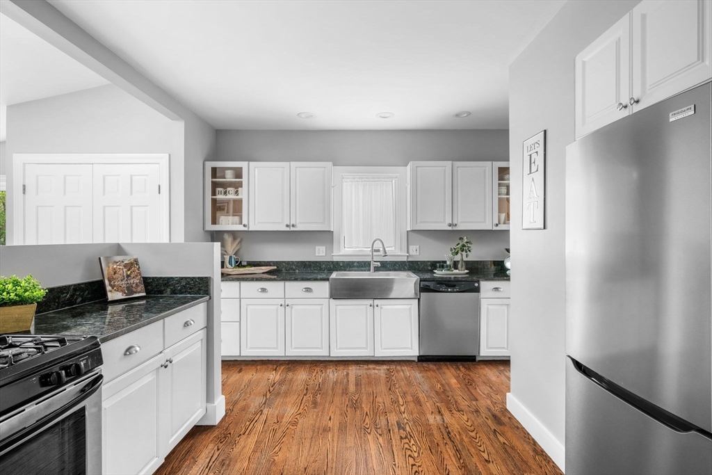 8 Baker Avenue Beverly, MA 01915 - Photo 6 of 40 a kitchen with granite countertop a refrigerator stove top oven and sink