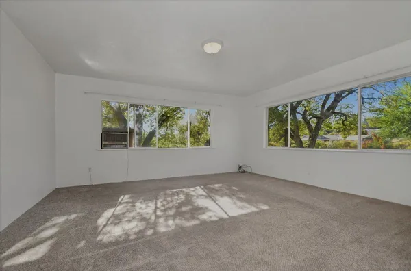 a view of kitchen and window with wooden floor