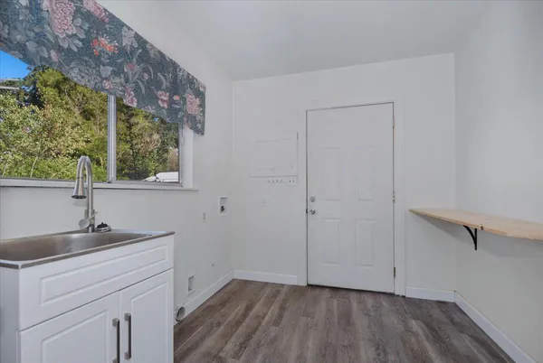 a kitchen with granite countertop a refrigerator and a stove top oven