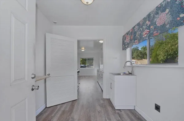 a view of a kitchen with wooden floor