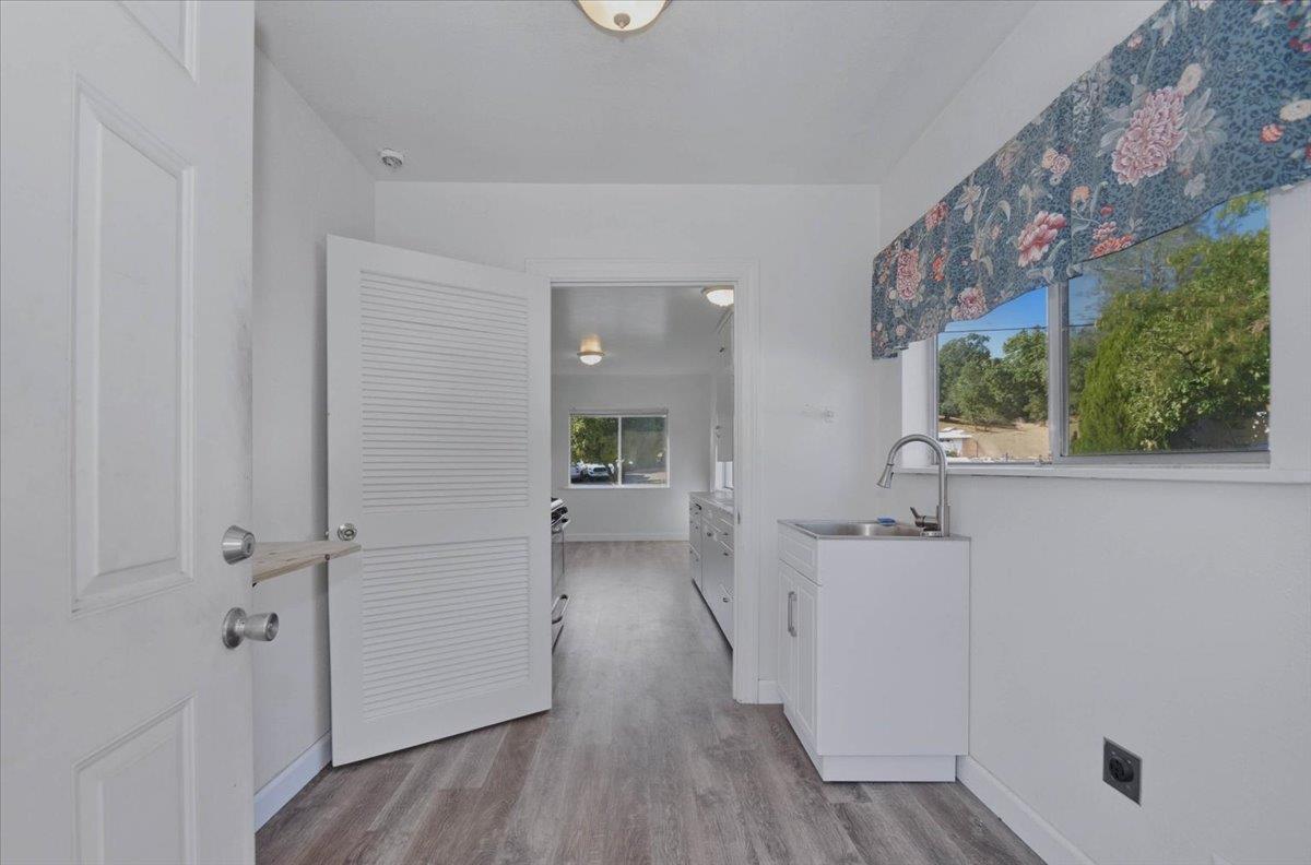 90 Gopher Flat Road Sutter Creek, CA 95685 - Photo 16 of 43 a view of a hallway to rooms and wooden floor