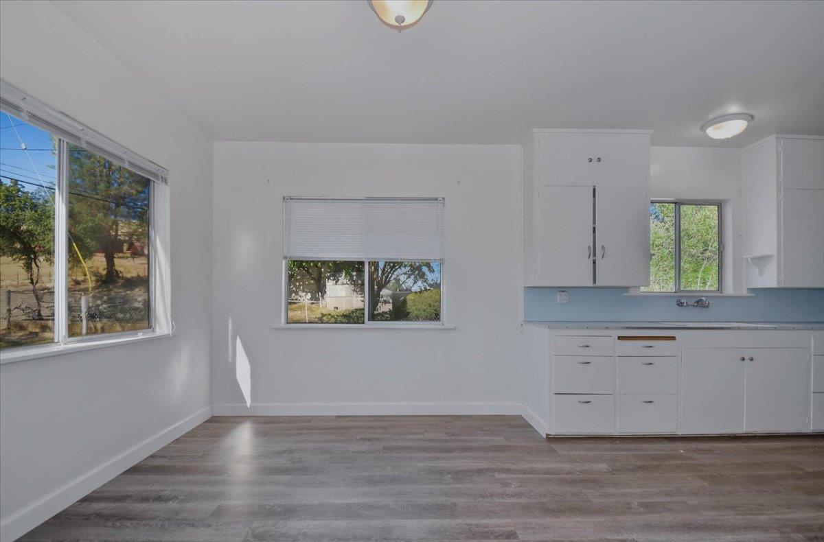 90 Gopher Flat Road Sutter Creek, CA 95685 - Photo 17 of 43 a view of kitchen and window with wooden floor