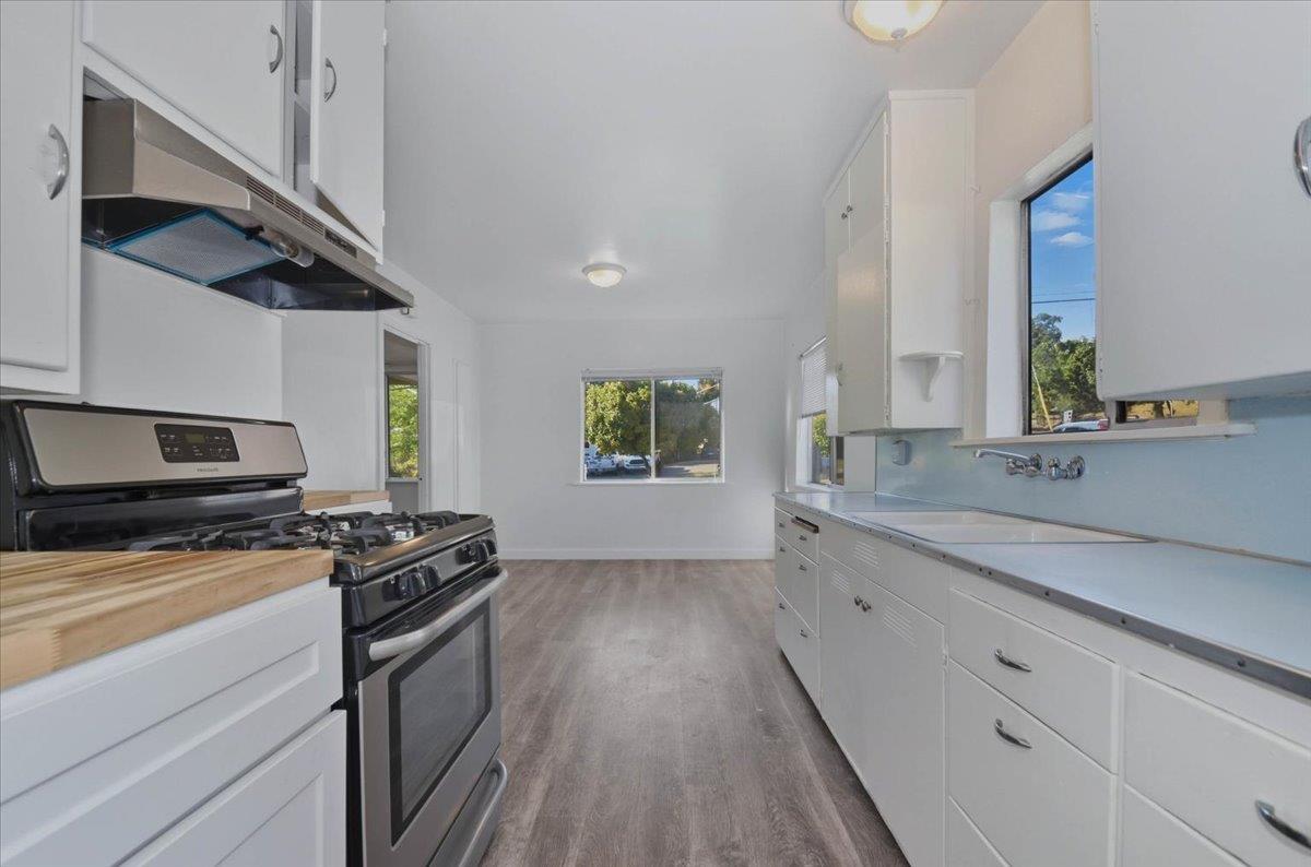 90 Gopher Flat Road Sutter Creek, CA 95685 - Photo 19 of 43 a kitchen with granite countertop a sink a stove and cabinets