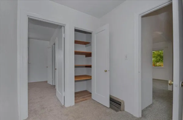 a view of room with window and hallway