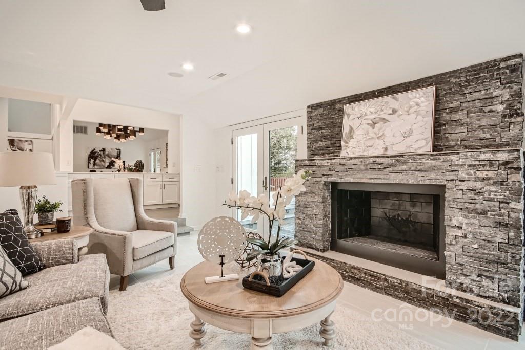 8000 Rising Meadow Road Charlotte, NC 28277 - Photo 13 of 28 a living room with furniture a fireplace and a large mirror
