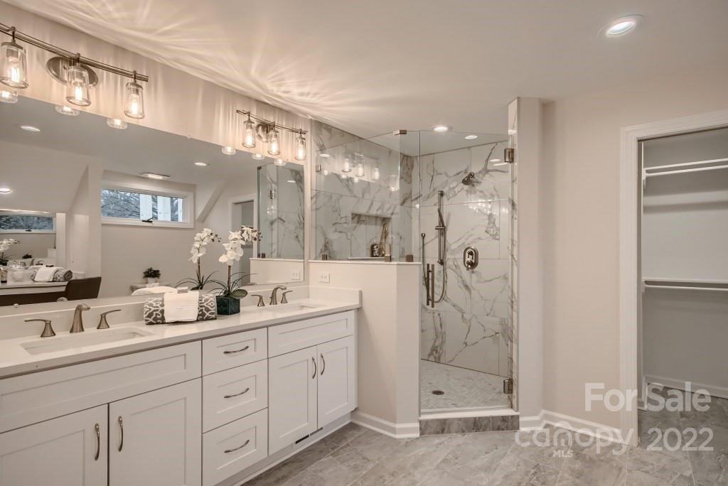 8000 Rising Meadow Road Charlotte, NC 28277 - Photo 17 of 28 a bathroom with a double vanity sink mirror and shower