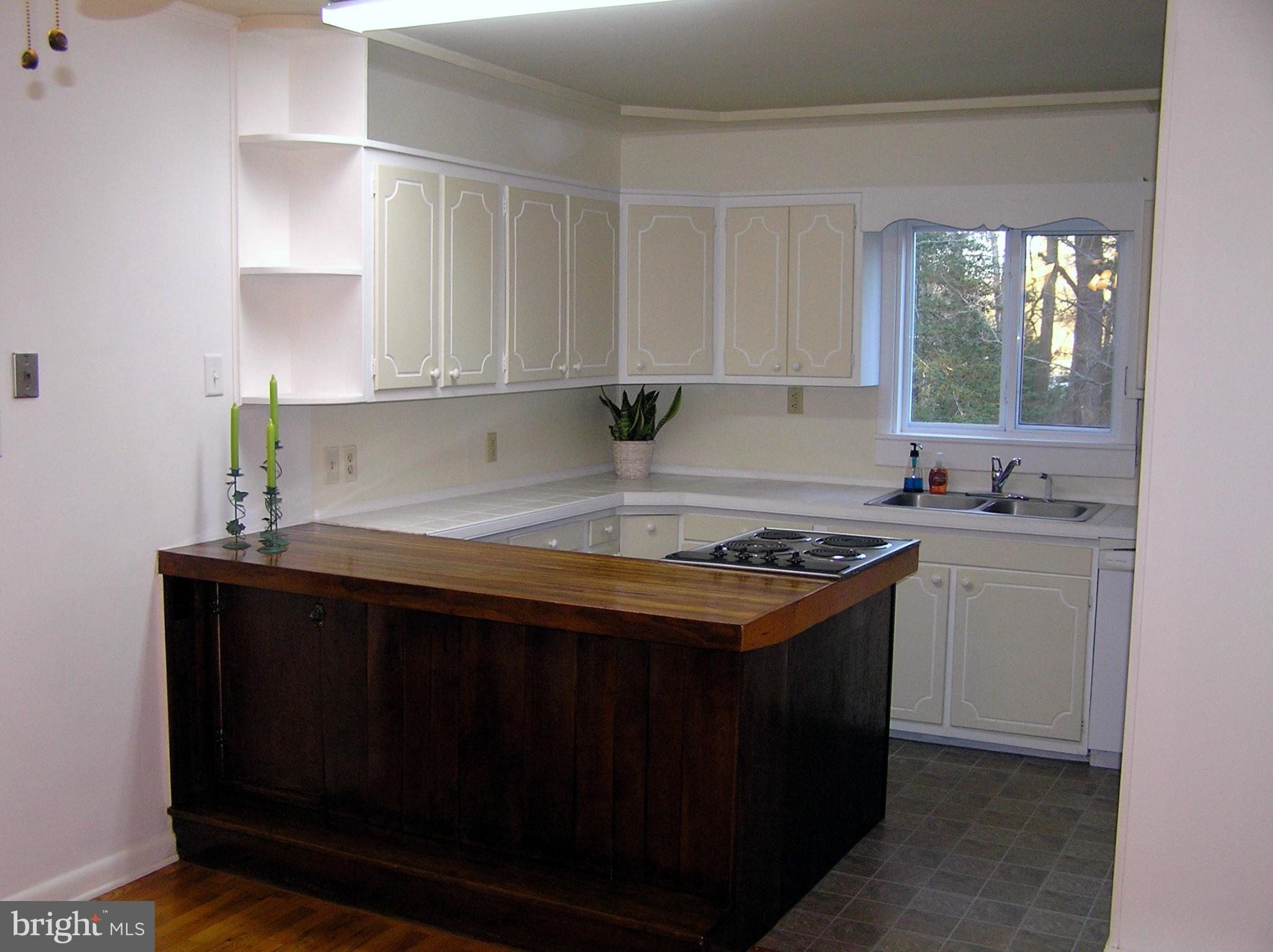4611 Bethlehem Road Preston, MD 21655 - Photo 16 of 26 a kitchen with a stove a sink and a window