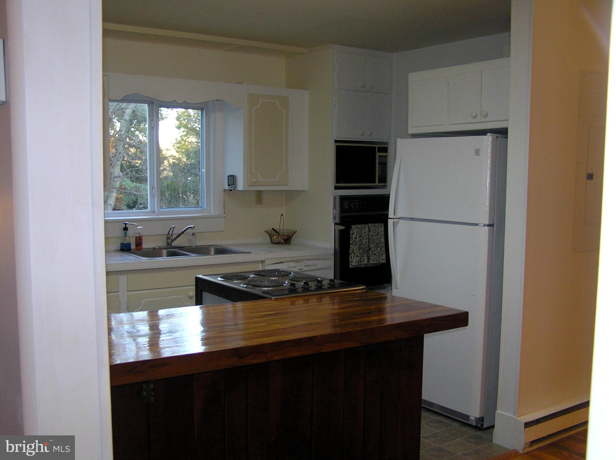 4611 Bethlehem Road Preston, MD 21655 - Photo 17 of 26 a kitchen with a refrigerator a stove a sink and a window