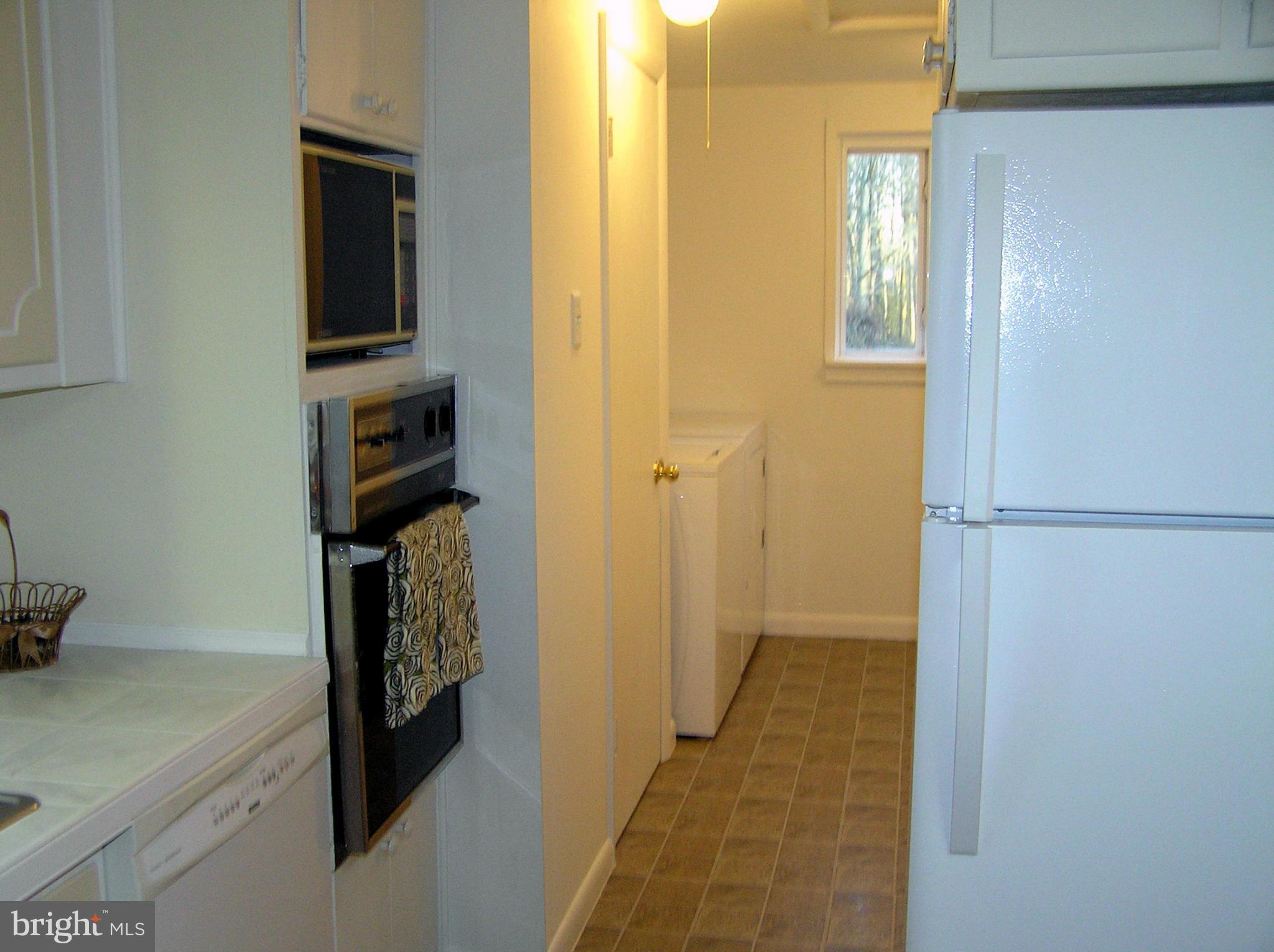 4611 Bethlehem Road Preston, MD 21655 - Photo 18 of 26 a view of a hallway with wooden floor and a living room