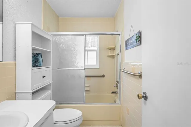 a bathroom with a toilet and shower
