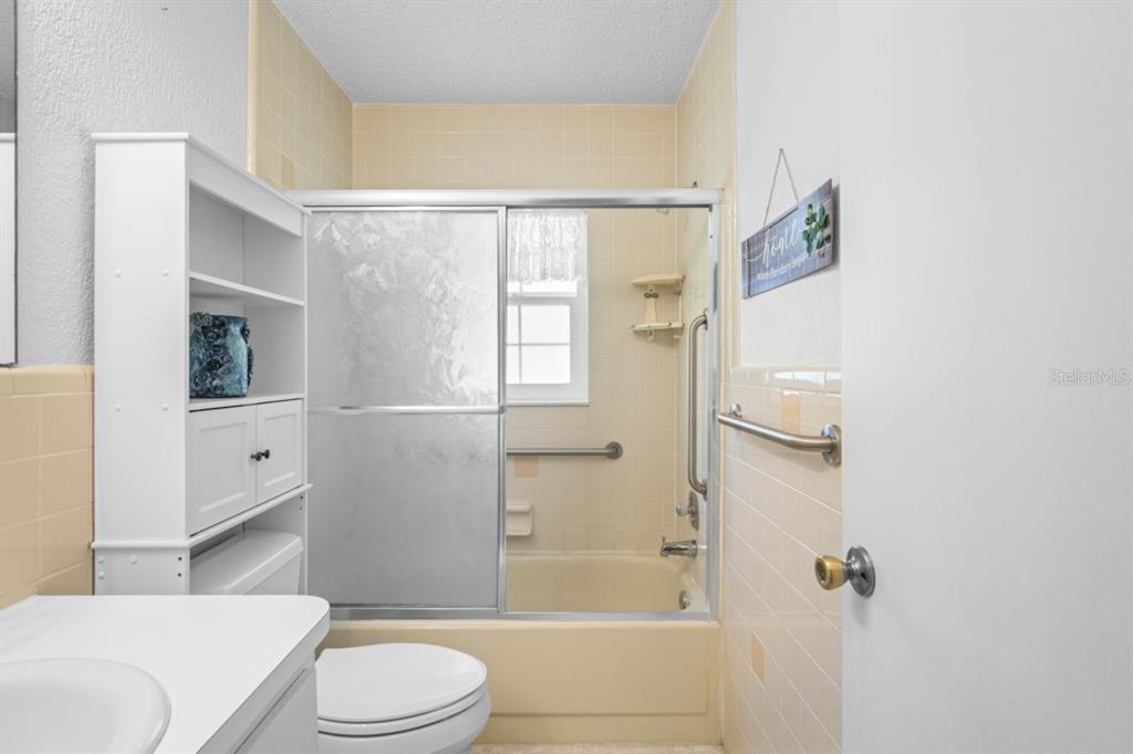 6702 Dartmoor Lane, Unit 7A New Port Richey, FL 34653 - Photo 15 of 40 a bathroom with a toilet and shower