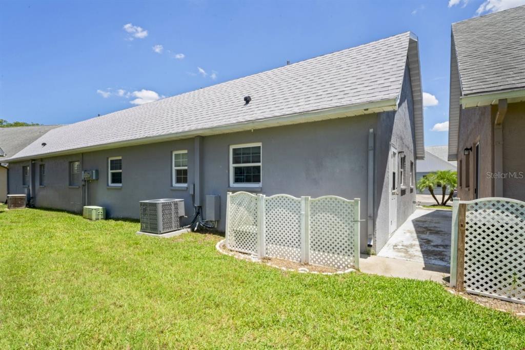 6702 Dartmoor Lane, Unit 7A New Port Richey, FL 34653 - Photo 17 of 40 a front view of house with yard and outdoor seating