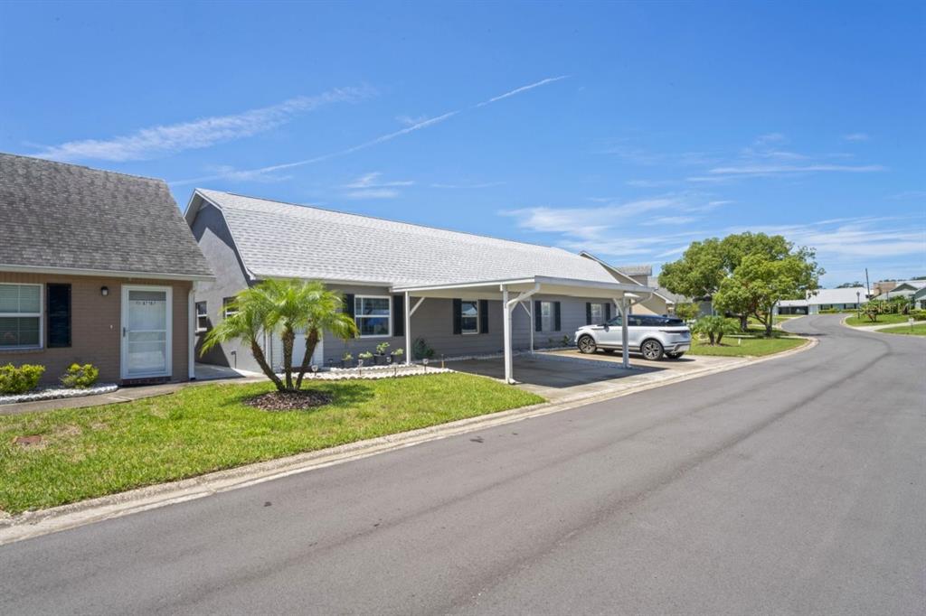 6702 Dartmoor Lane, Unit 7A New Port Richey, FL 34653 - Photo 19 of 40 a front view of house with yard and green space