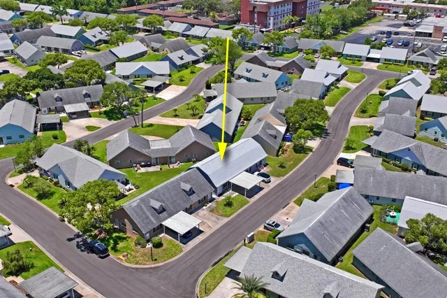 an aerial view of residential houses with outdoor space