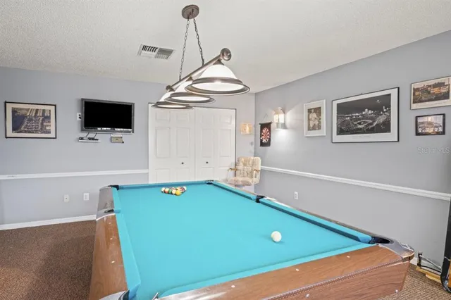 a room with pool table and a flat screen tv