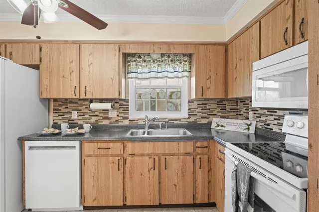 a kitchen with stainless steel appliances a sink stove and cabinets