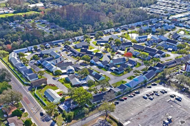an aerial view of residential houses with outdoor space