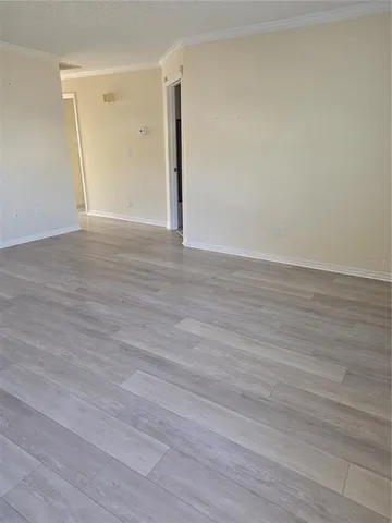 a view of an empty room and wooden floor