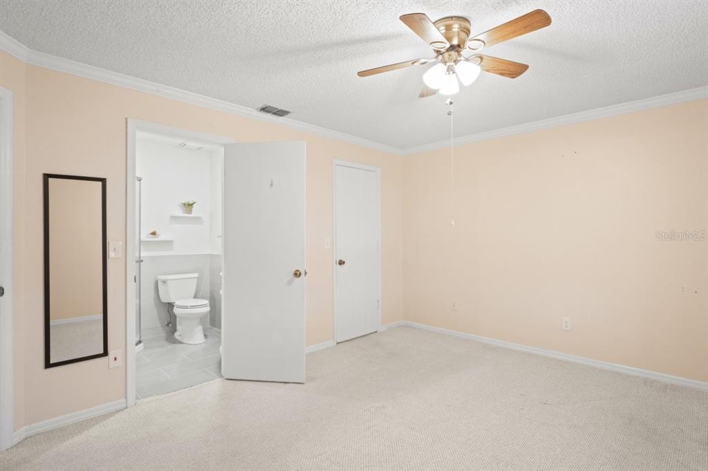 6702 Dartmoor Lane, Unit 7A New Port Richey, FL 34653 - Photo 7 of 40 a view of a big room with a chandelier fan and a ceiling fan