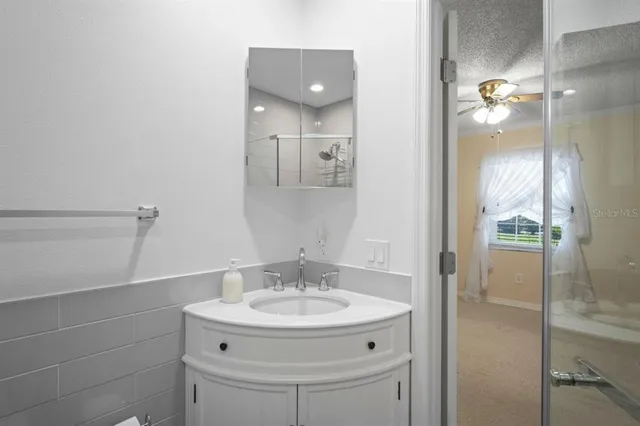 a bathroom with a sink and mirror