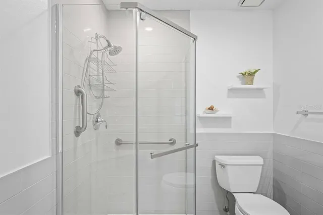 a bathroom with a toilet and a shower