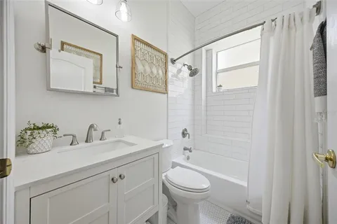 a bathroom with a double vanity sink mirror and toilet