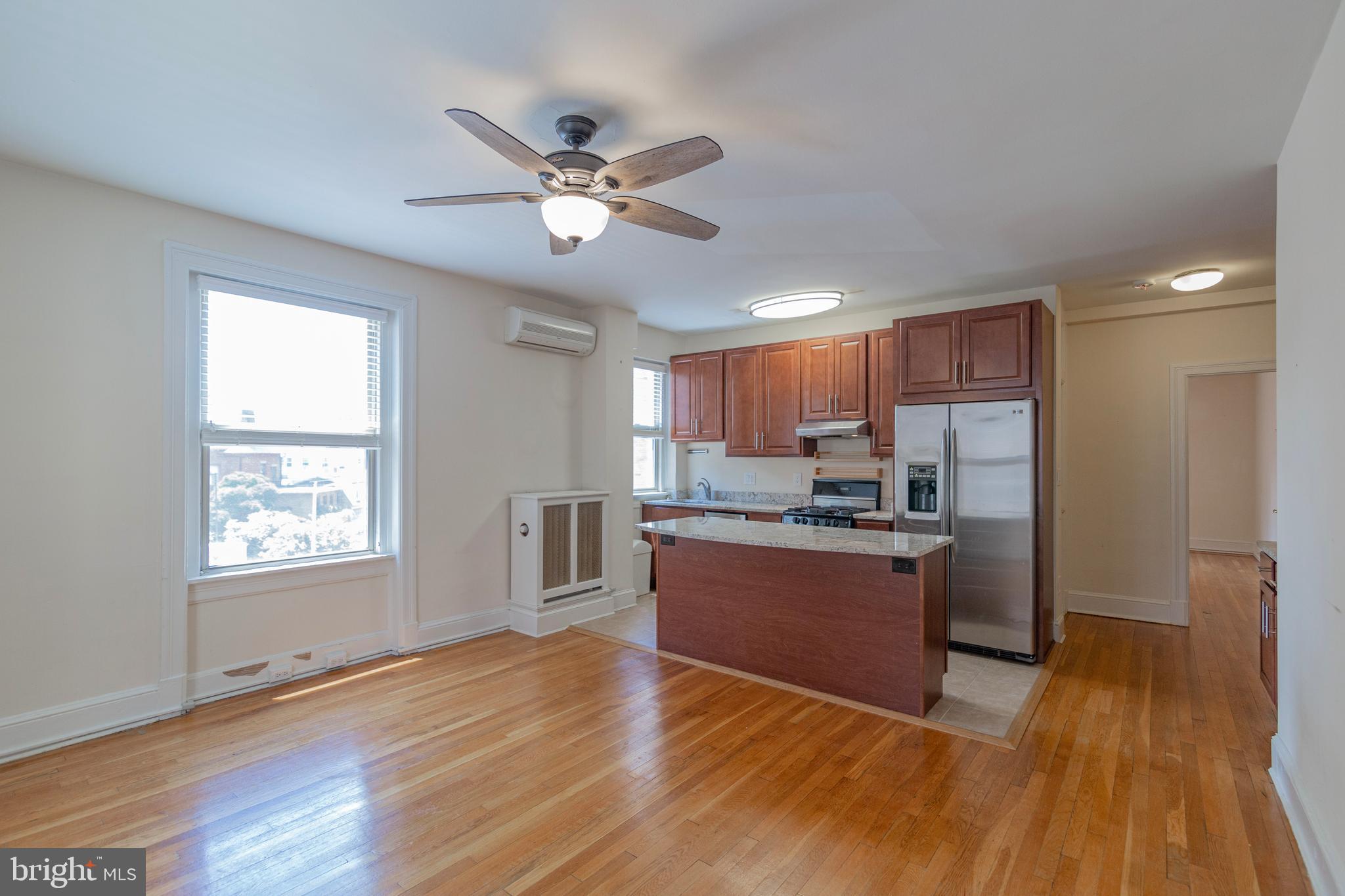 1910 Kalorama Road Northwest, Unit 307 Washington, DC 20009 - Photo 11 of 19 a view of a kitchen with wooden floor and a window