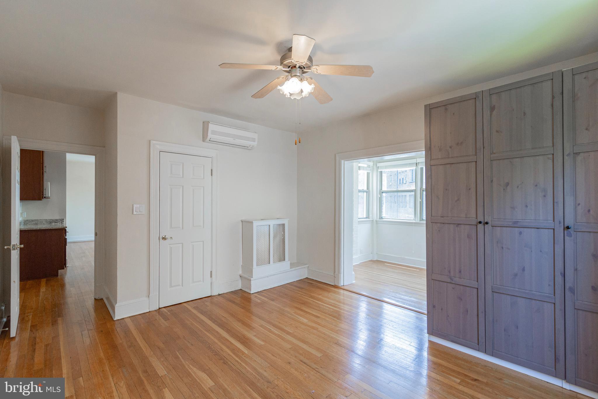 1910 Kalorama Road Northwest, Unit 307 Washington, DC 20009 - Photo 13 of 19 a view of an empty room with wooden floor