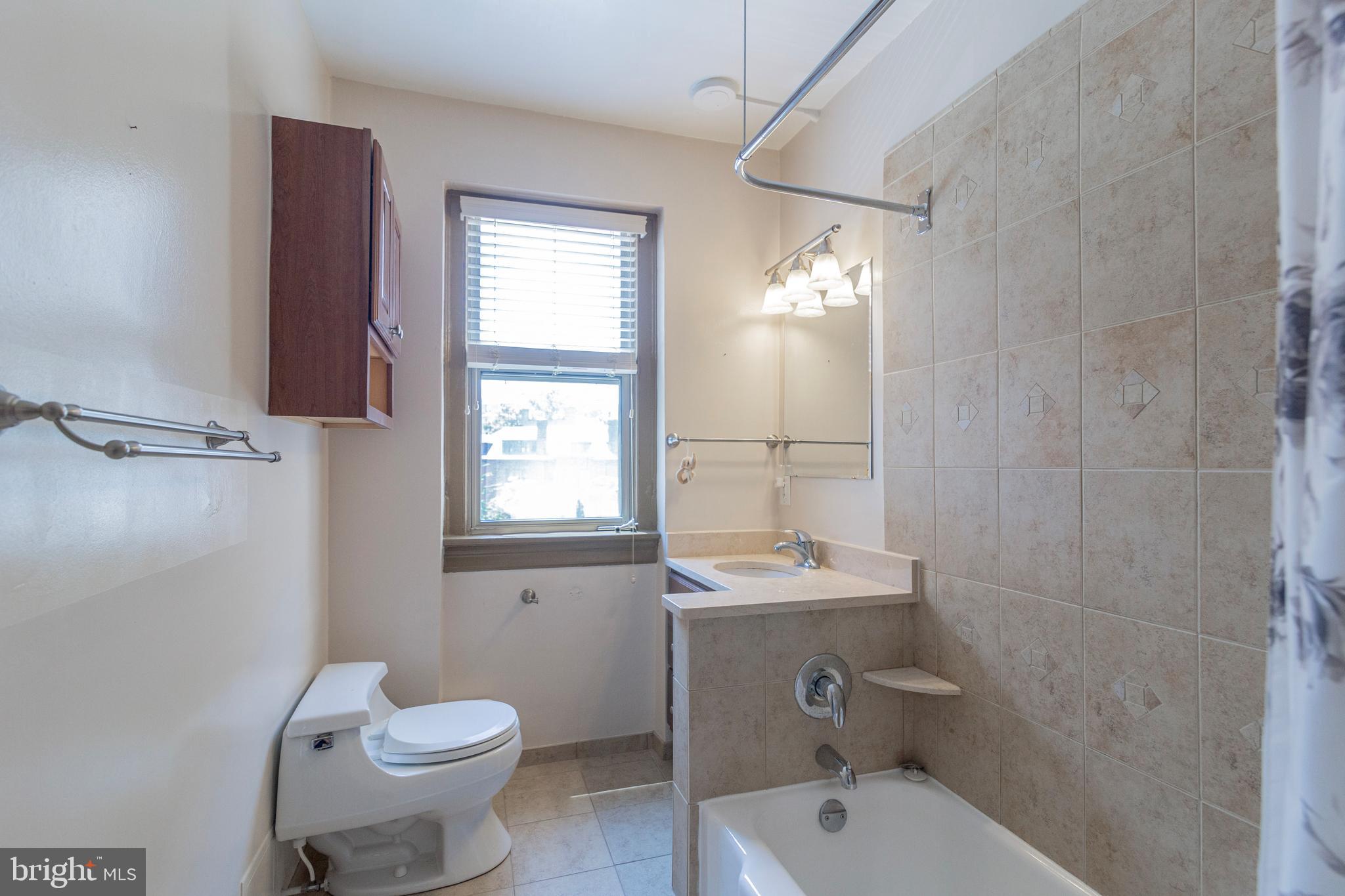 1910 Kalorama Road Northwest, Unit 307 Washington, DC 20009 - Photo 16 of 19 a bathroom with a sink toilet and shower