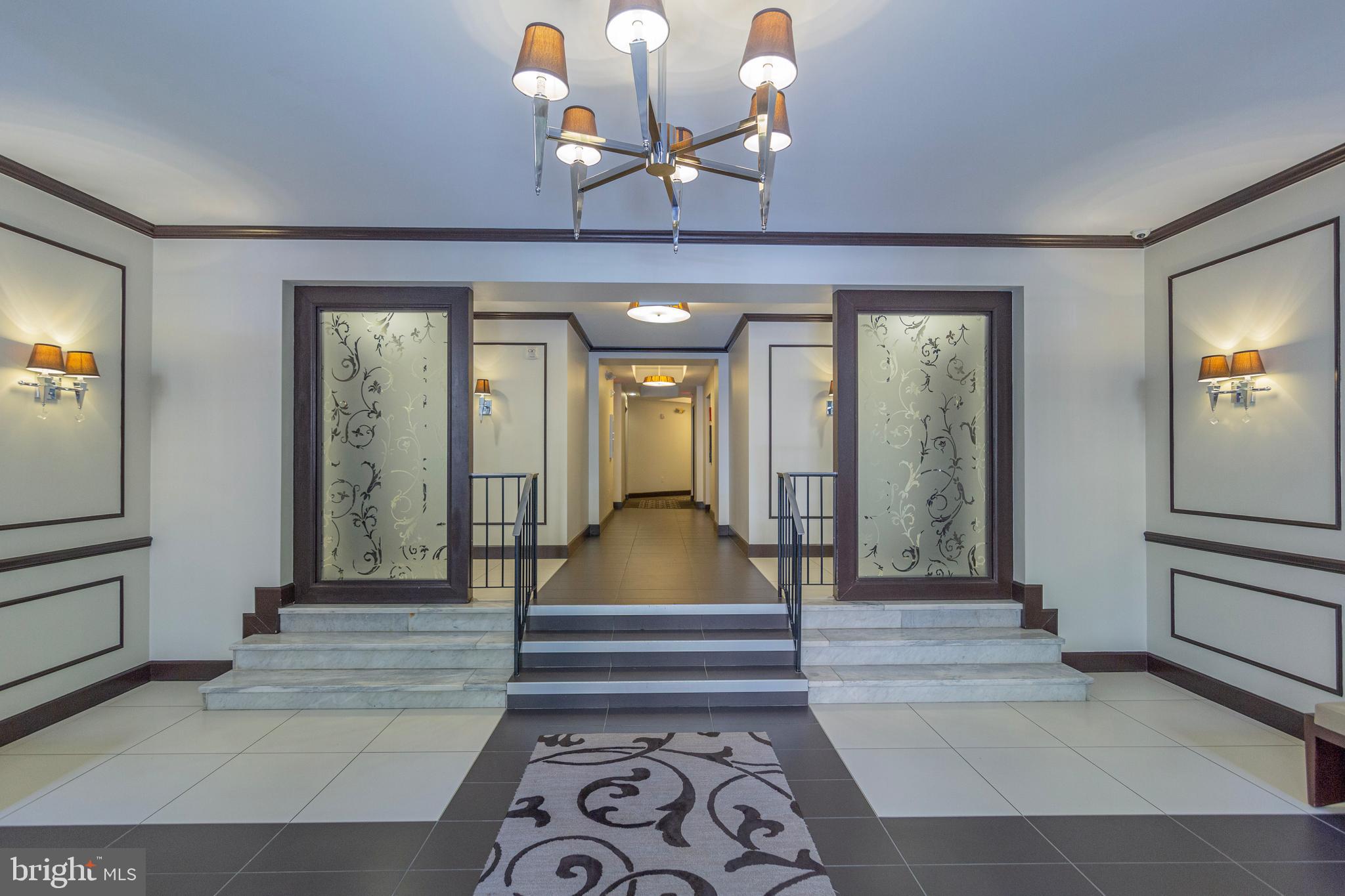 1910 Kalorama Road Northwest, Unit 307 Washington, DC 20009 - Photo 3 of 19 a living room with furniture and a chandelier